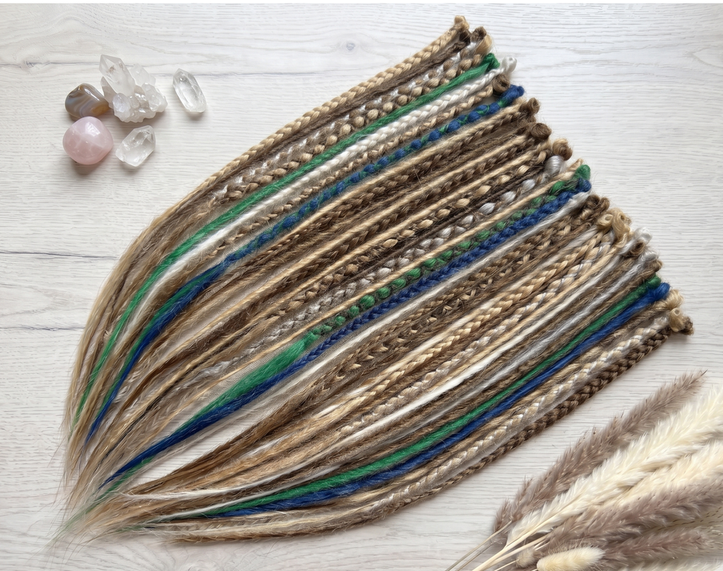 Full set of boho synthetic dreadlocks in blonde, brown, white, blue and green tones with loose ends, photographed on a soft lifestyle background.