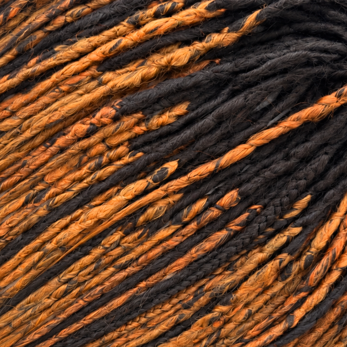 Detailed close-up of dark brown and copper ginger crochet dreadlocks showing the handmade fibre texture, braided patterns, colour blending and soft natural-looking finish.
