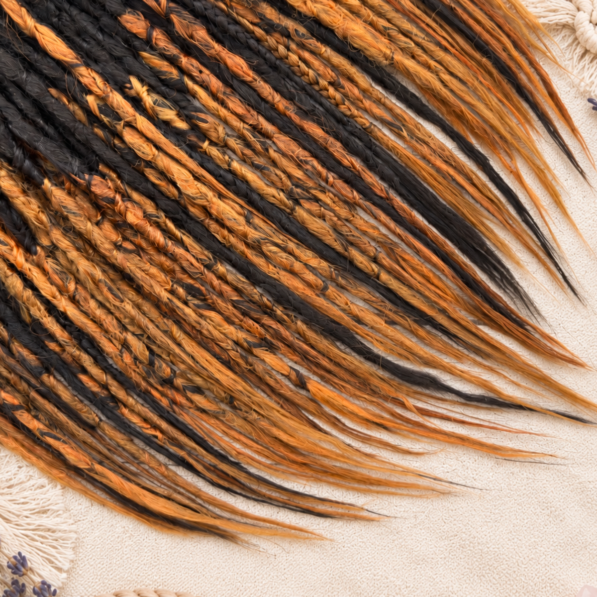 Close-up of ombre brown to copper ginger synthetic dreadlock extensions showing handmade crochet texture, braided strands, dark brown contrast and fine loose wispy ends.