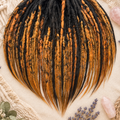 Top view of a full set of ombre dark brown to ginger dreadlock extensions, showing the colour transition, handmade crochet texture, mixed braids and natural loose ends.