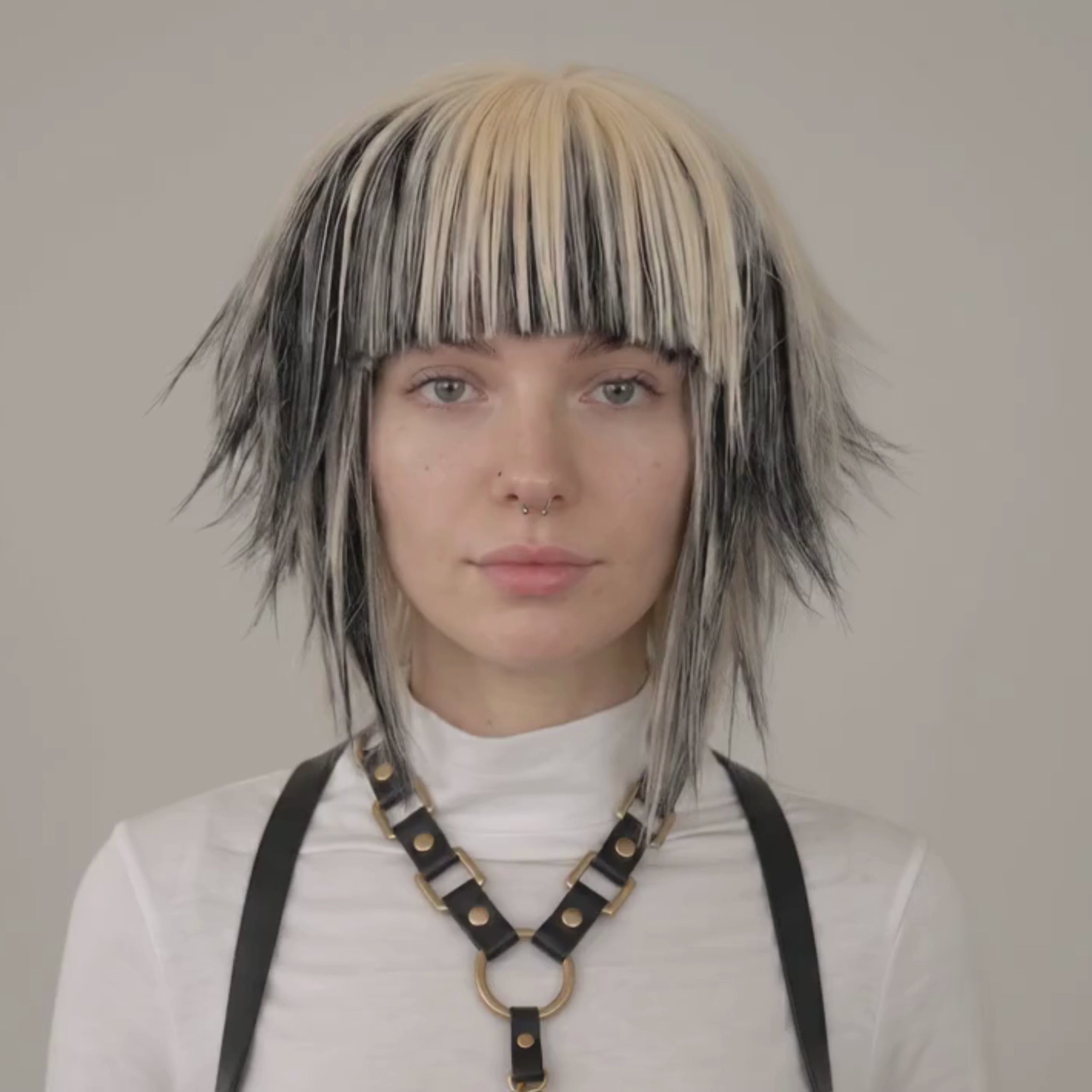 Blonde and black scene wig with spiky layered cut and long bangs, short emo Y2K alternative cosplay wig shown on model.