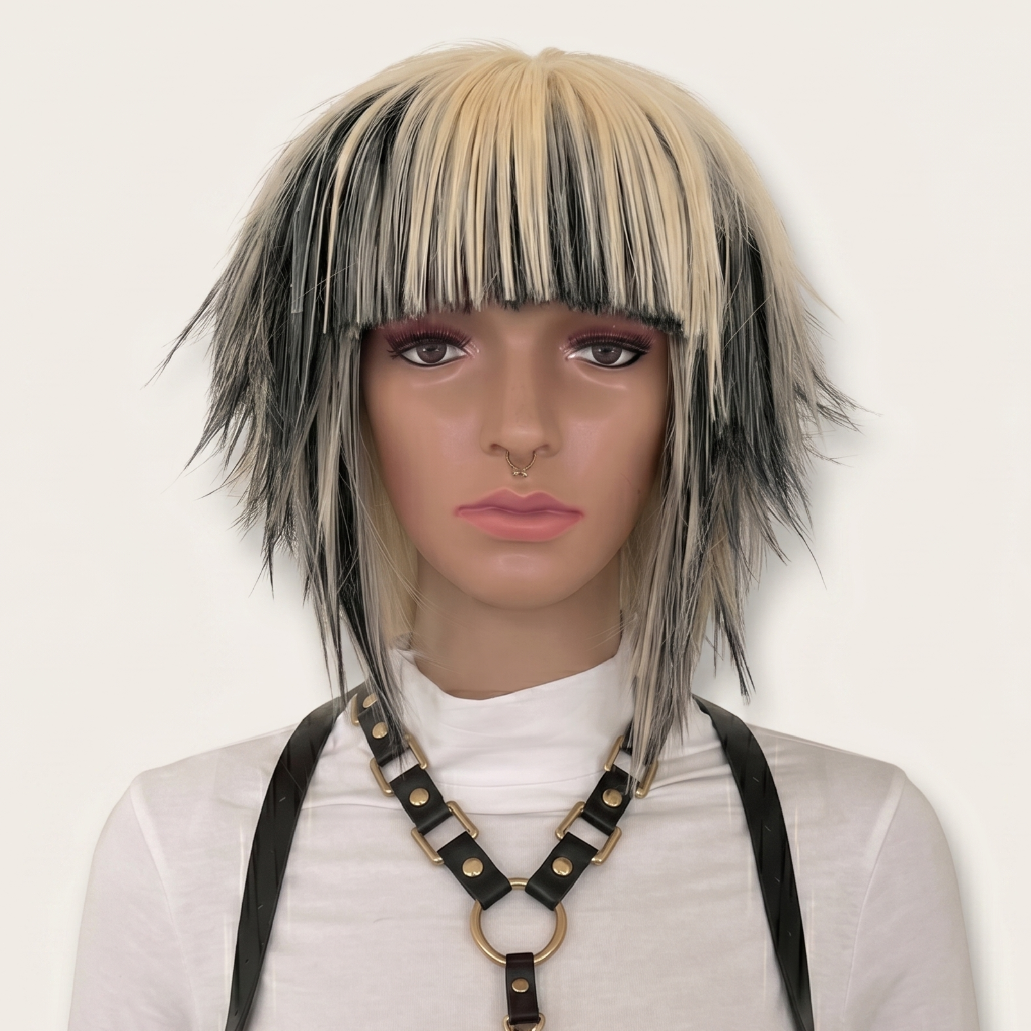 Short blonde and black scene wig with choppy spiky layers and straight bangs, Y2K emo alternative cosplay wig front view.