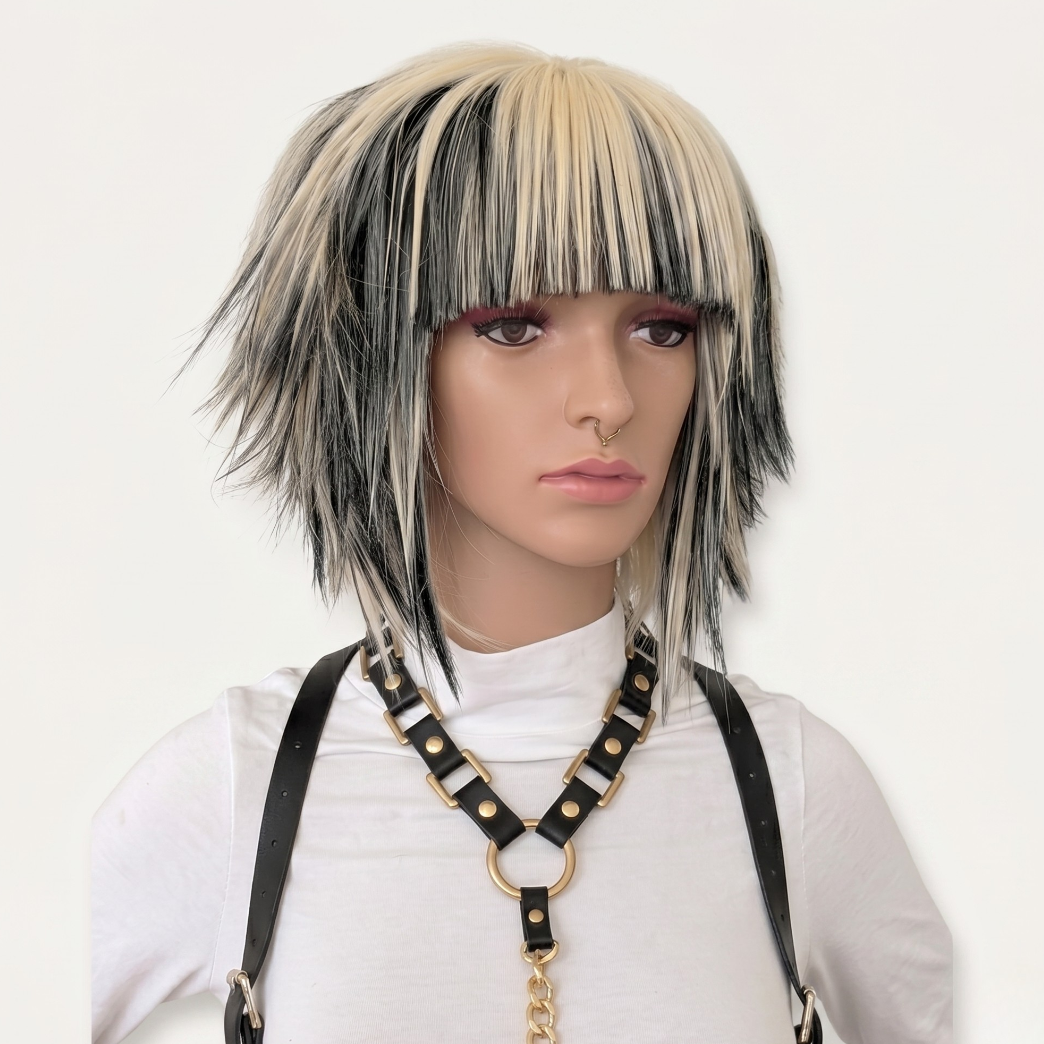 Short blonde and black scene wig with choppy spiky layers and straight bangs, Y2K emo alternative cosplay wig front view.